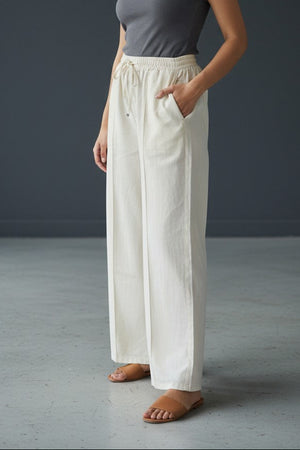 Woman wearing Pavline premium high waist black flared pants with sleeveless black top for office and casual fashion.