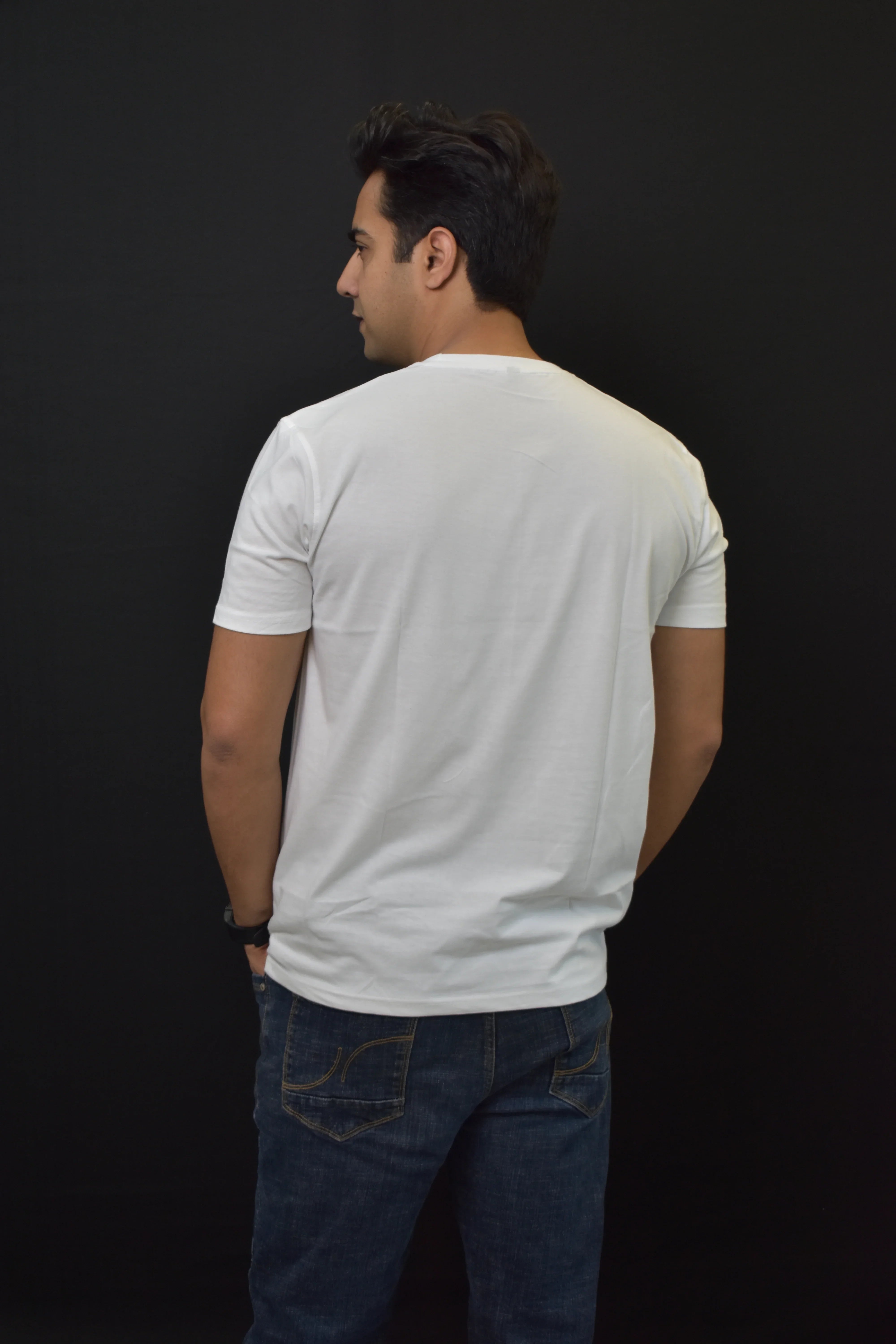 Pavline white t-shirt and blue jeans, back view on male model, black background