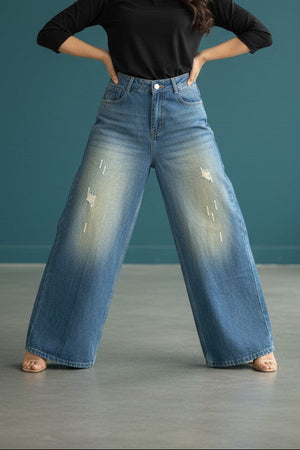 Pavline women's vintage blue wide leg high rise denim jeans with subtle distressed detailing.