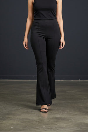 Woman wearing Pavline premium high waist black flared pants with sleeveless black top for office and casual fashion.