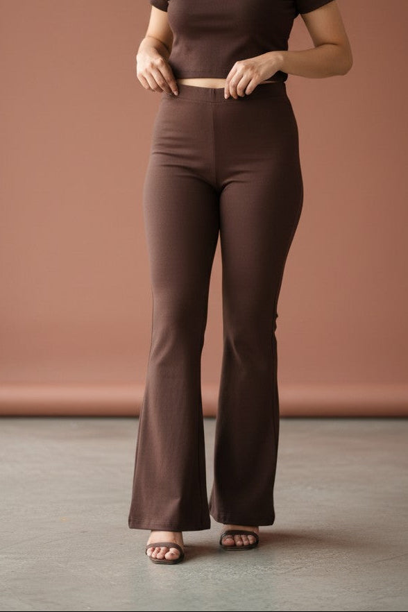 Woman wearing Pavline premium high waist brown flared pants with sleeveless black top for office and casual fashion.