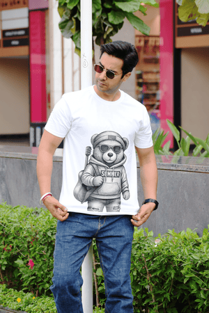 Man wearing a white t-shirt with a graphic design outdoors