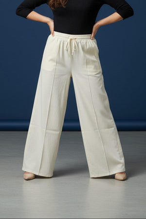 Woman wearing Pavline premium high waist black flared pants with sleeveless black top for office and casual fashion.