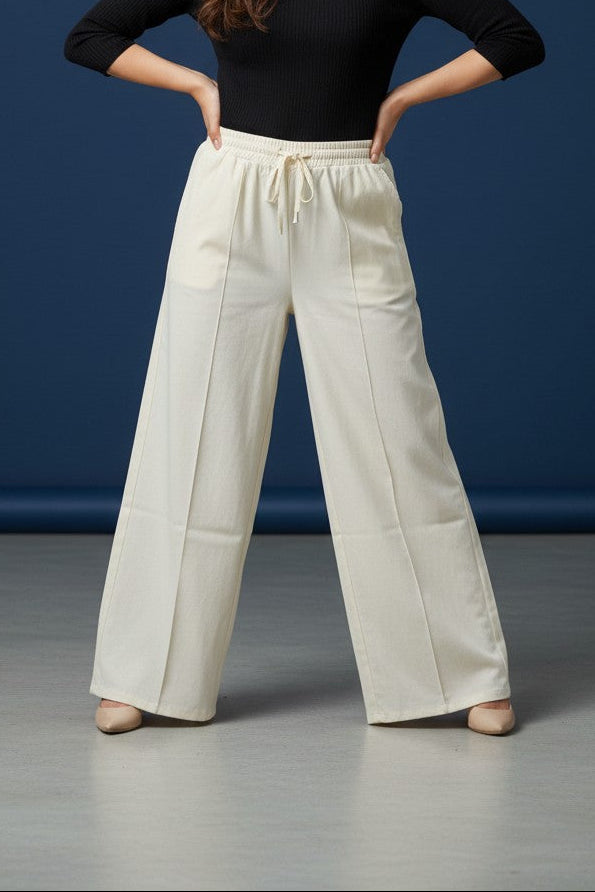 Woman wearing Pavline premium high waist black flared pants with sleeveless black top for office and casual fashion.