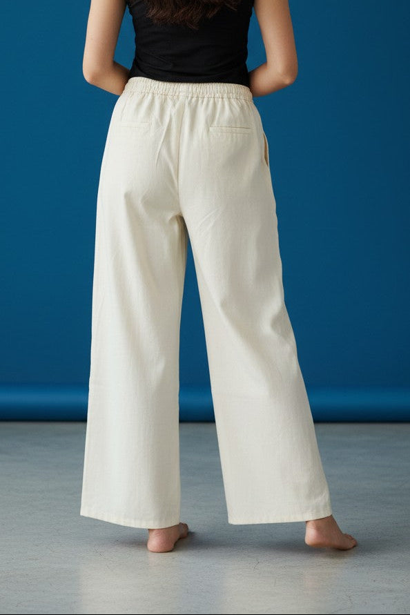 Woman wearing Pavline premium high waist black flared pants with sleeveless black top for office and casual fashion.