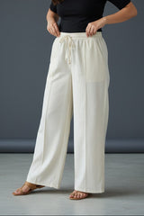 Woman wearing Pavline premium high waist black flared pants with sleeveless black top for office and casual fashion.