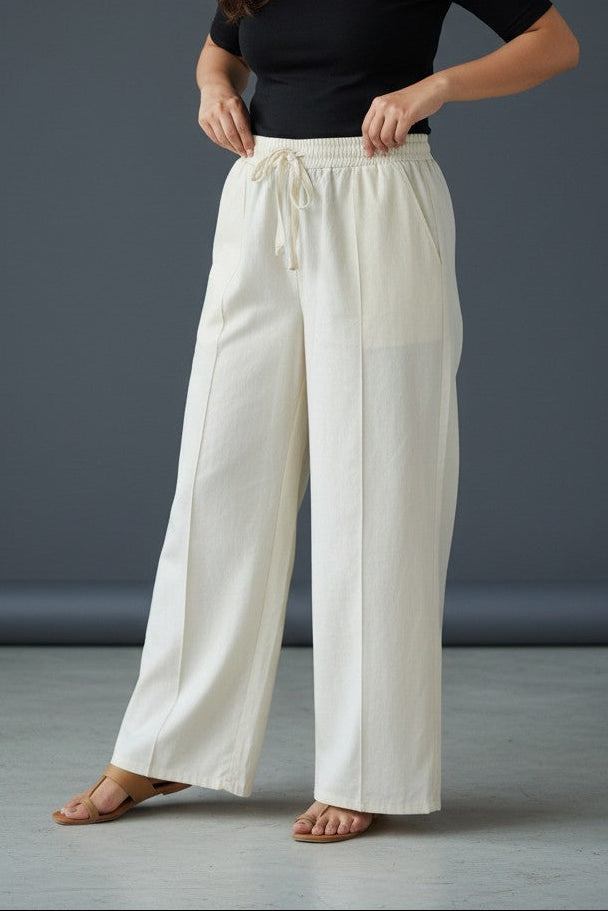 Woman wearing Pavline premium high waist black flared pants with sleeveless black top for office and casual fashion.