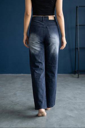 Woman wearing Pavline dark indigo high waist wide leg denim jeans with a black crop top for a modern Korean-inspired casual look.
