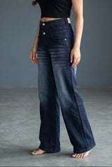 Woman wearing Pavline dark indigo high waist wide leg denim jeans with a black crop top for a modern Korean-inspired casual look.