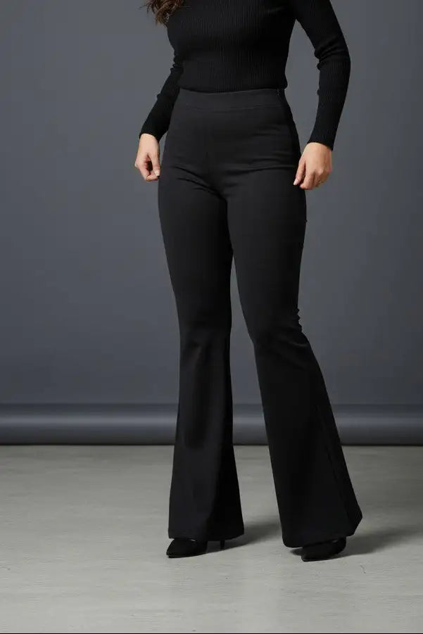 Woman wearing Pavline premium high waist black flared pants with sleeveless black top for office and casual fashion.